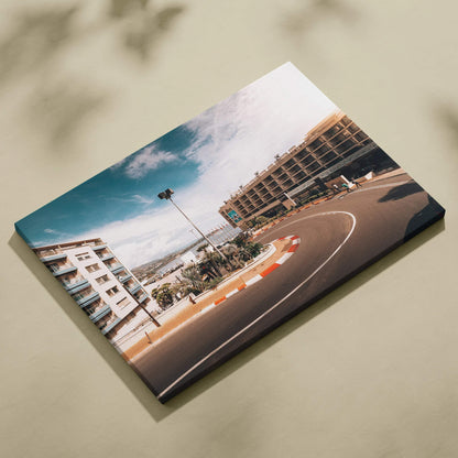 Canvas wall art featuring a curved F1 track corner with modern buildings under a bright blue sky.