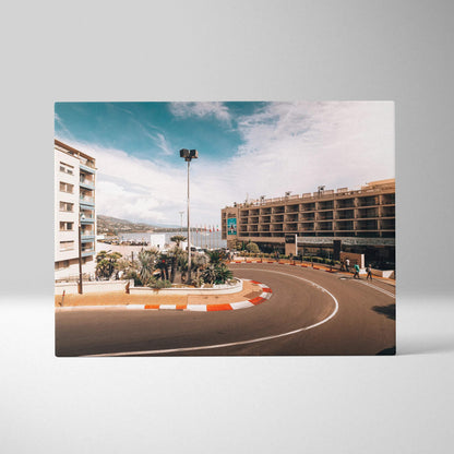 Canvas wall art featuring a sharp F1 track corner with modern buildings and clear blue sky in soft tones.