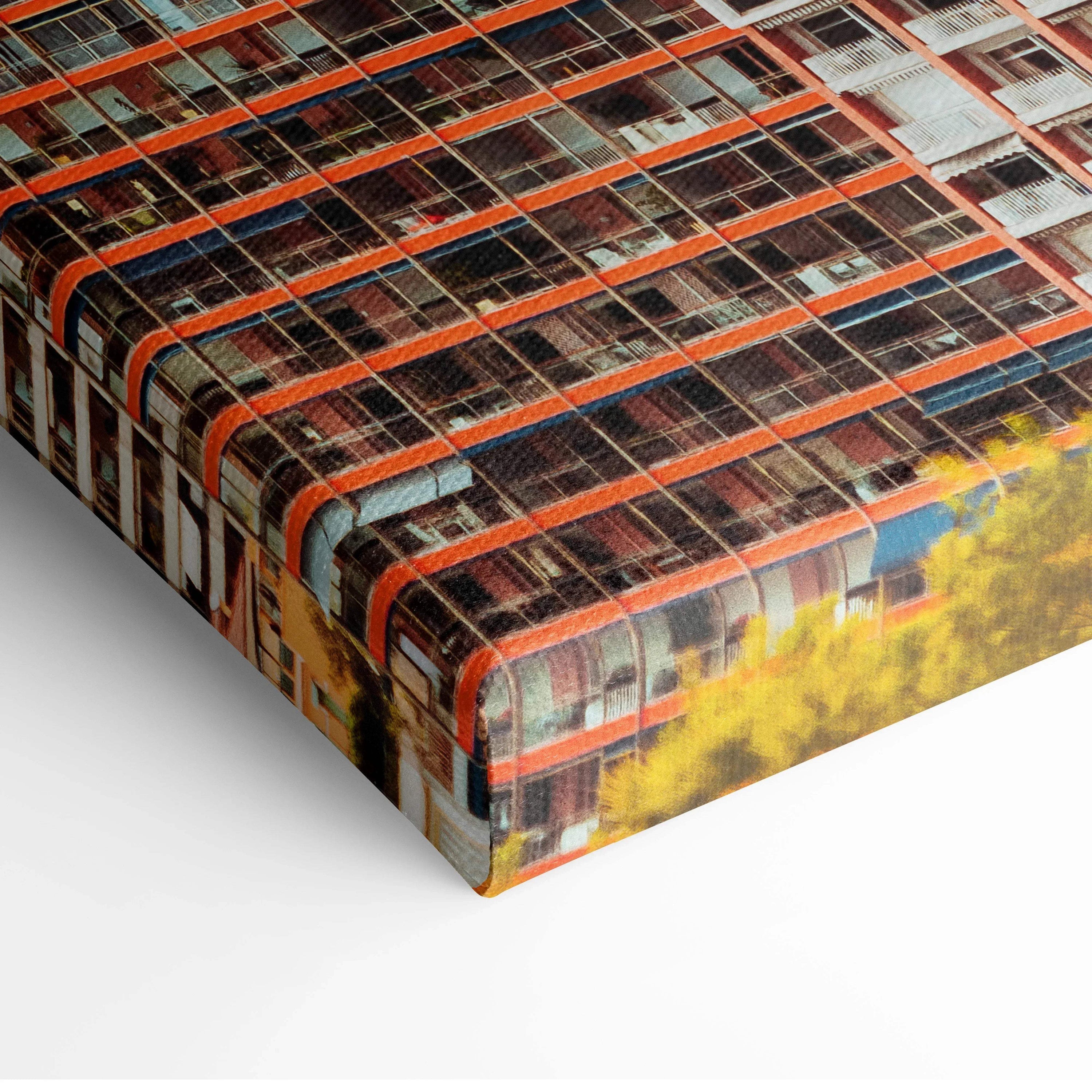Close-up of premium canvas art wall print featuring detailed architectural building design with orange and black color tones.
