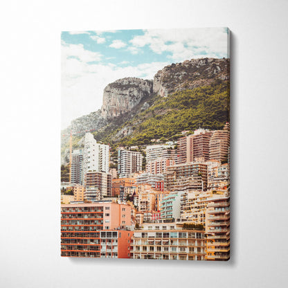 Vertical canvas art wall print featuring detailed urban architecture with mountainous backdrop under blue sky.