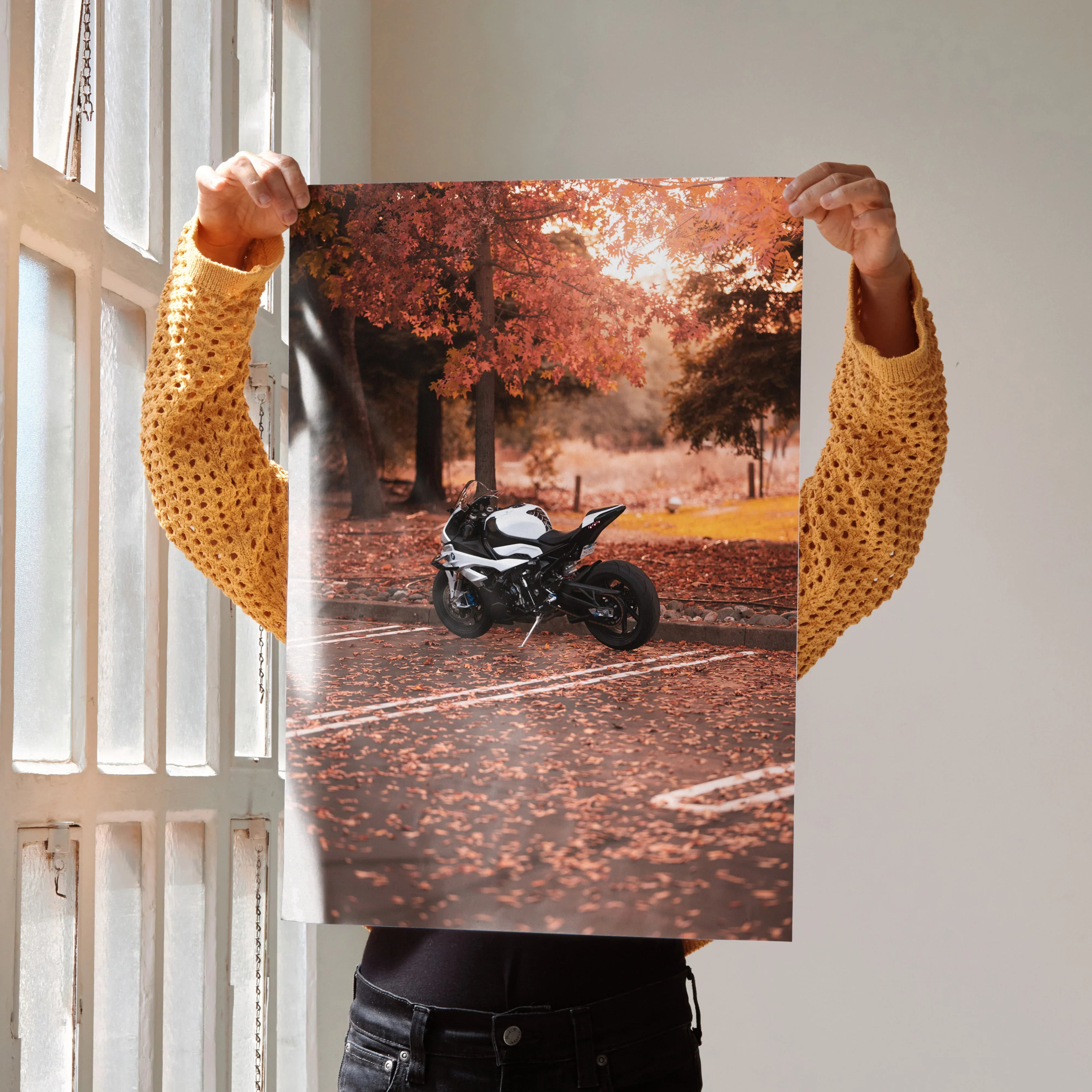 Poster wall art featuring a black BMW S1000RR motorcycle in a forest with autumn leaves.