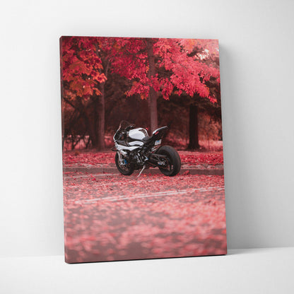 Vertical canvas art of a black BMW S1000RR motorcycle on a road with red autumn trees background.