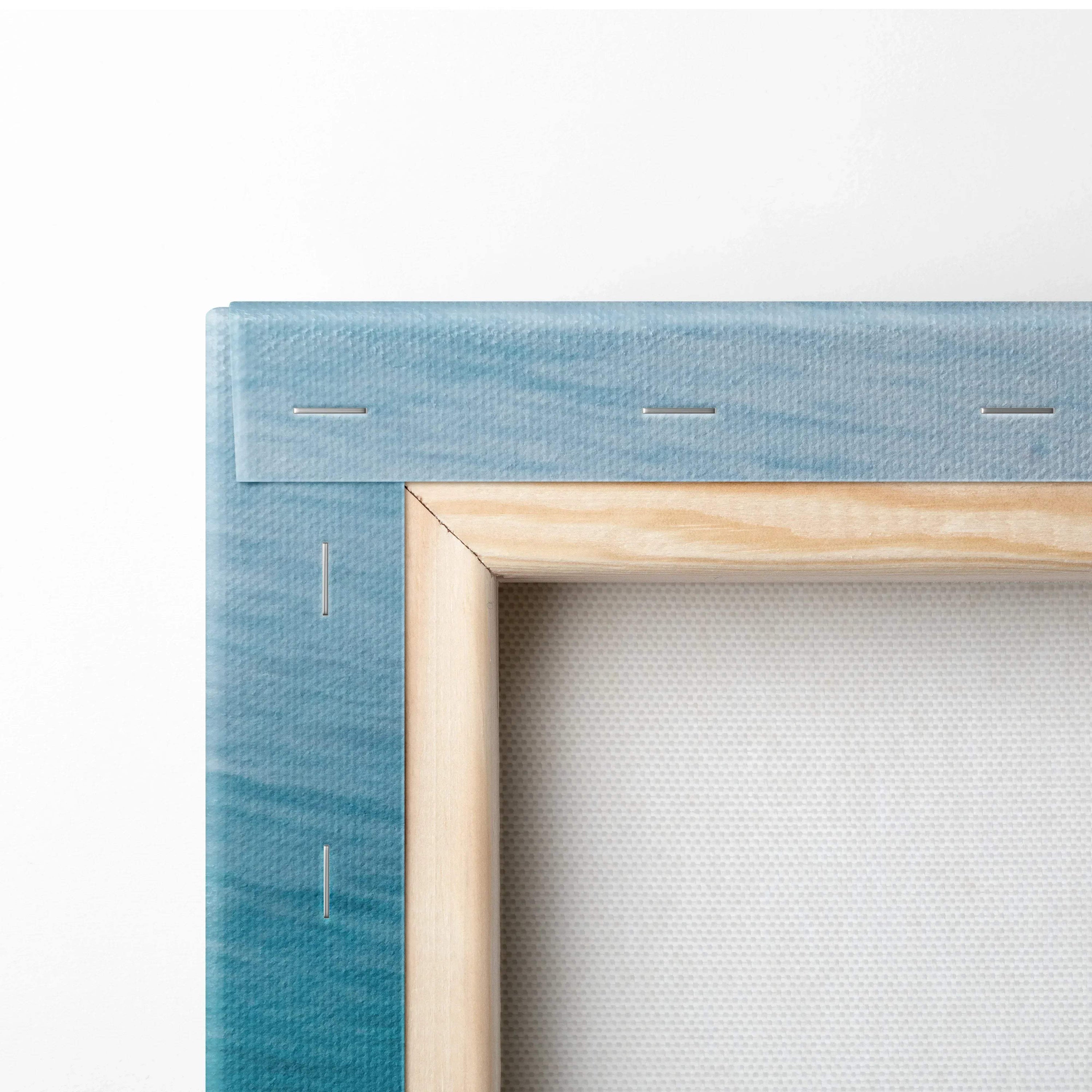 Close-up of wooden frame and blue canvas edge with stitched detailing for wall art canvas print.
