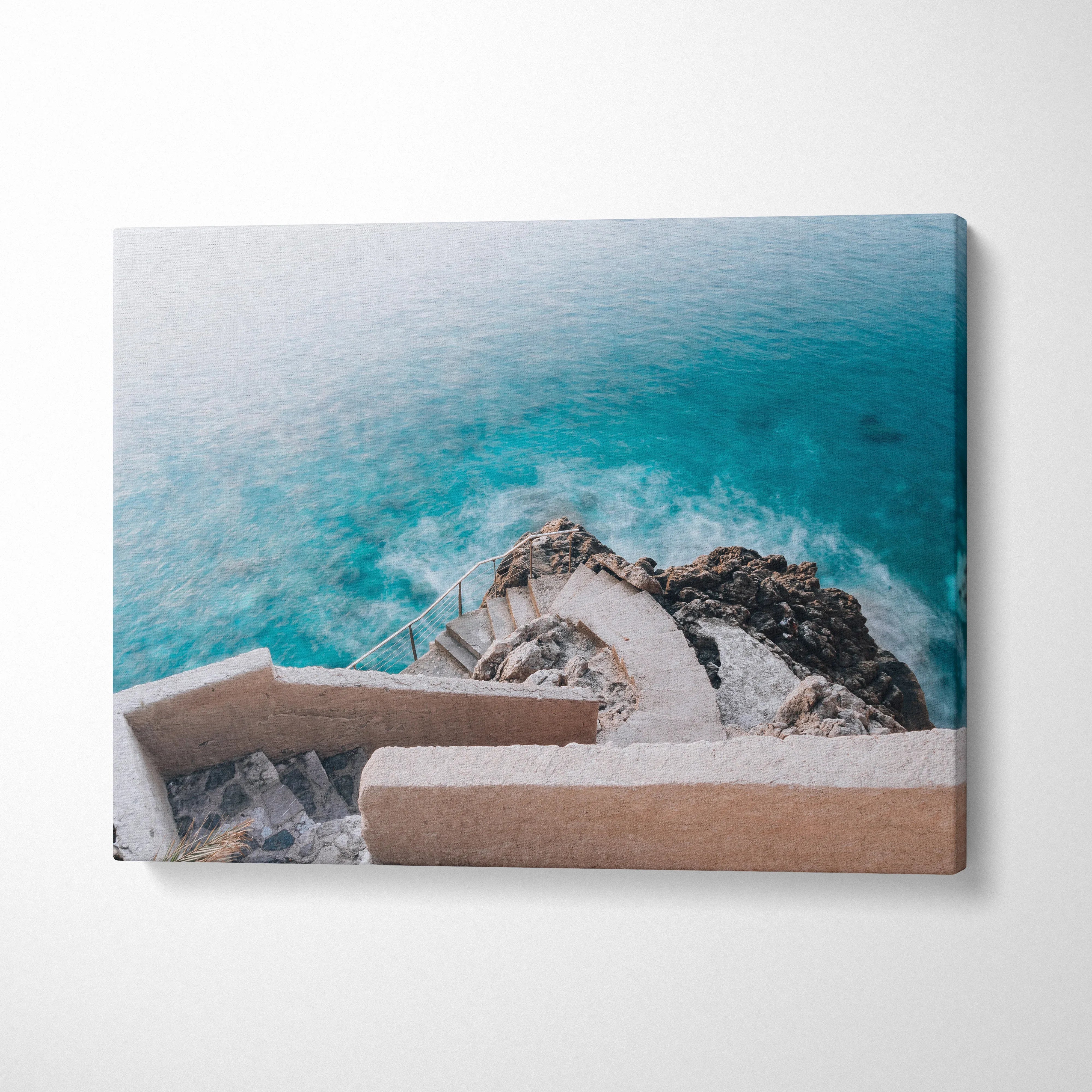 Canvas wall art featuring elegant architectural steps descending to a vibrant turquoise beach ocean scene.