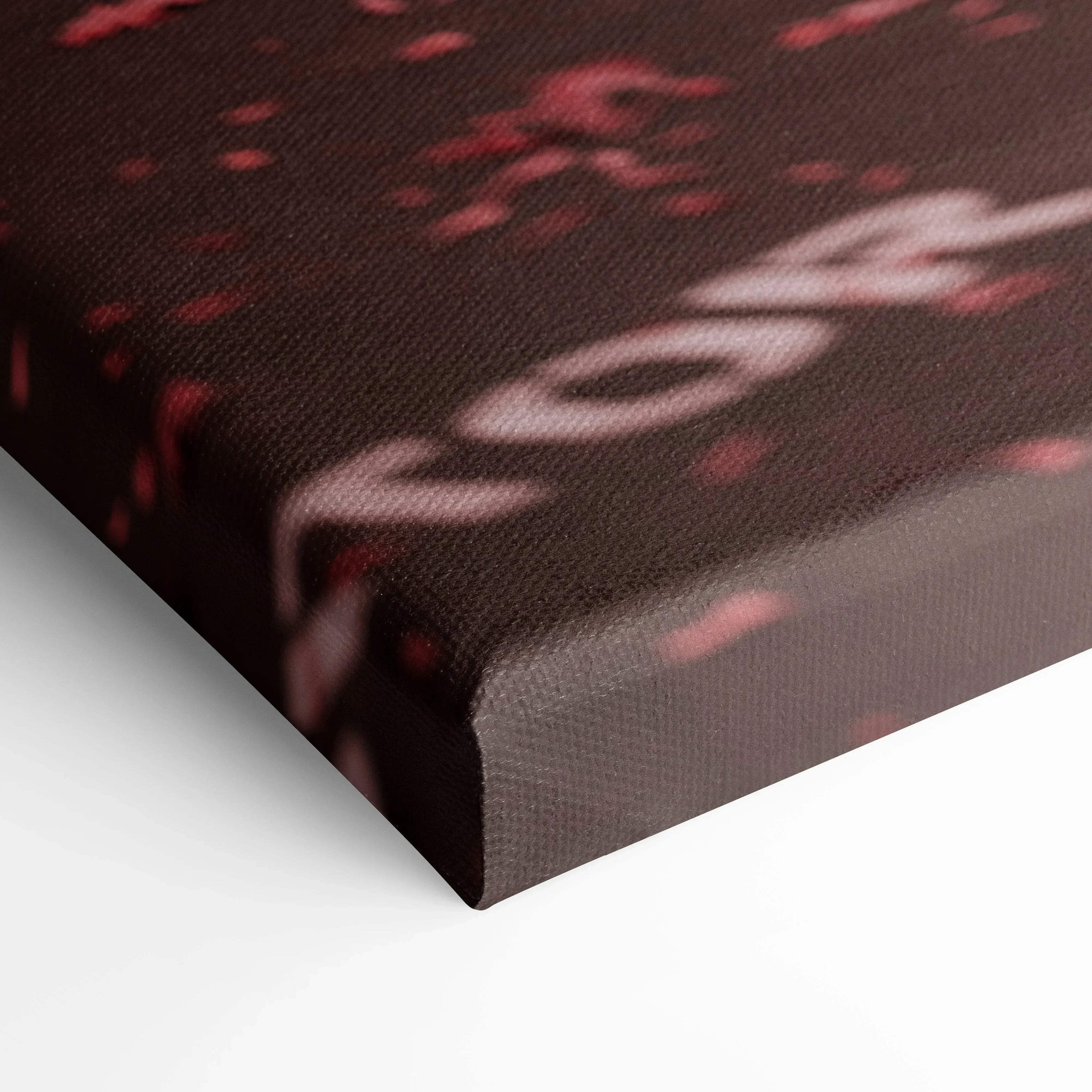 Close-up of textured black and red canvas wall art with abstract design and subtle text details.