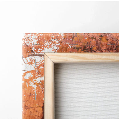 Close-up of vertical canvas art with orange and white abstract design and natural wood frame edge.