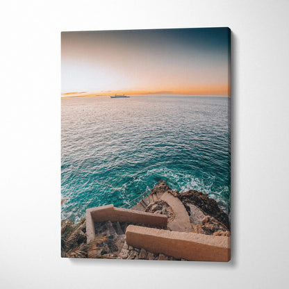 Canvas wall art of ocean view with rocky shore and sunset sky, vertical format.
