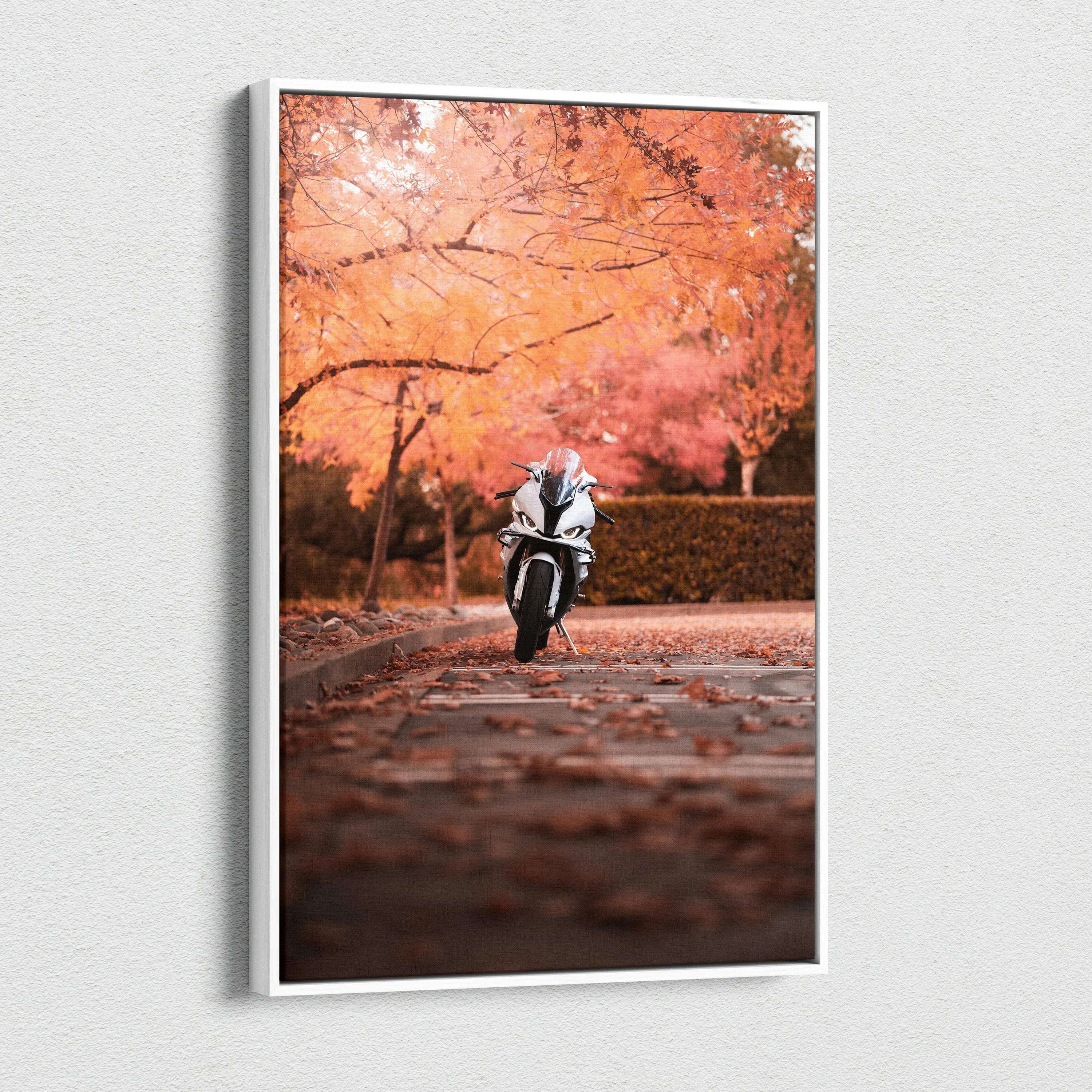 Vertical canvas art of a BMW S1000RR motorcycle on a leaf-covered path with autumn trees backdrop.