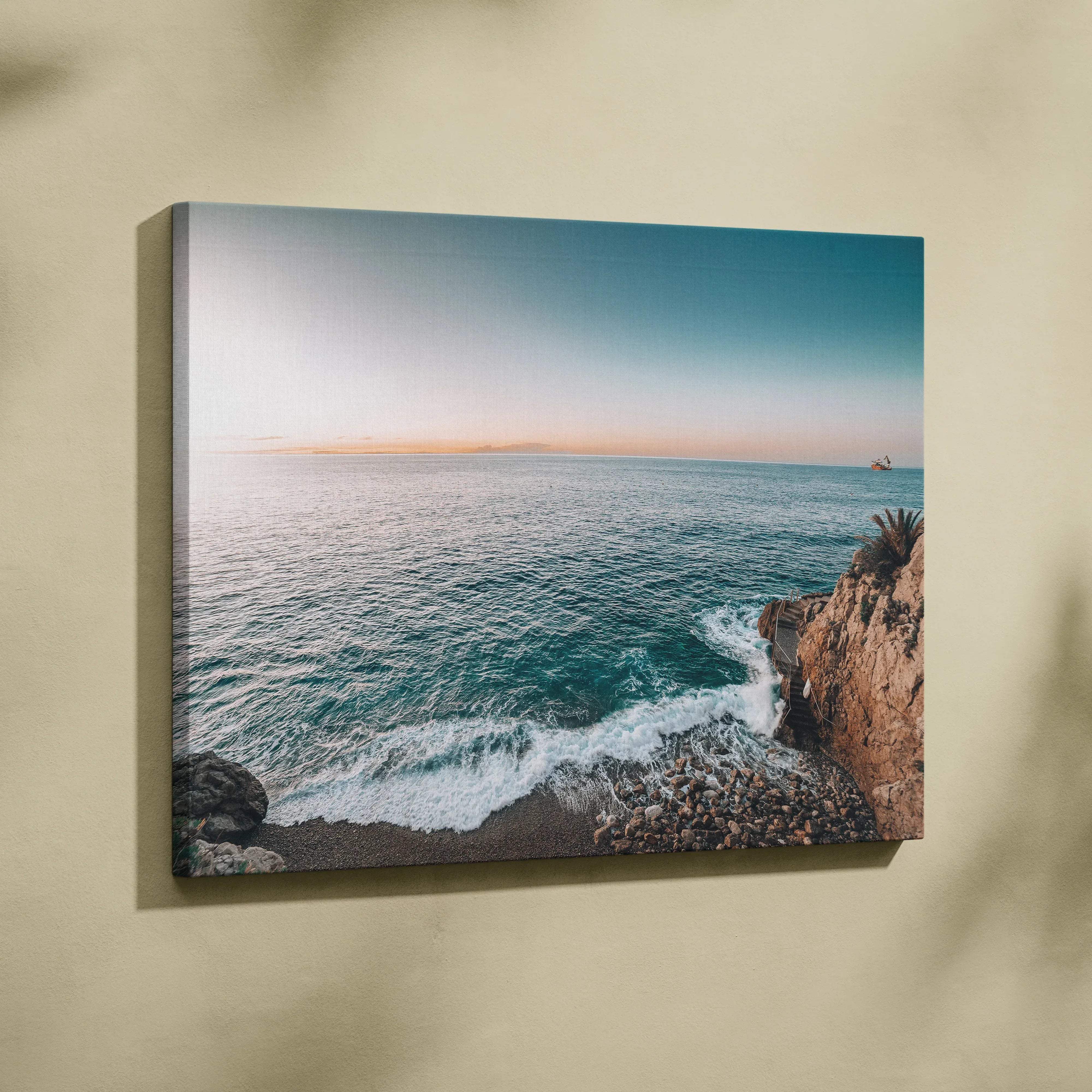 Coastal canvas wall art with turquoise waves on rocky shores at sunset