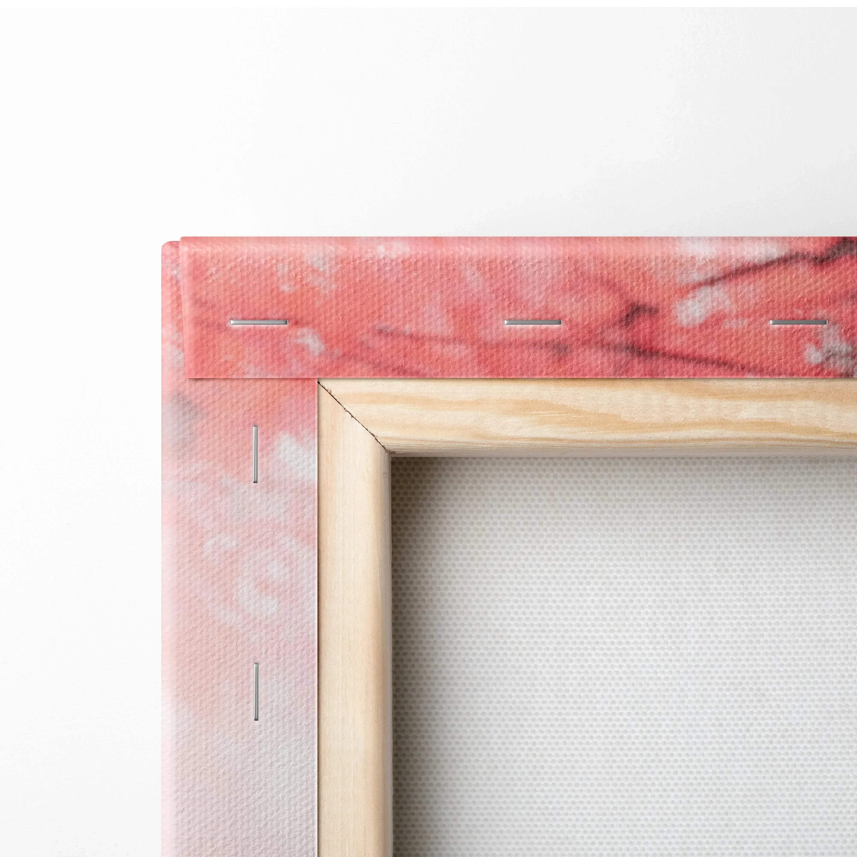 Close-up of wooden frame corner with pink printed canvas stretched and stapled for wall art canvas print.