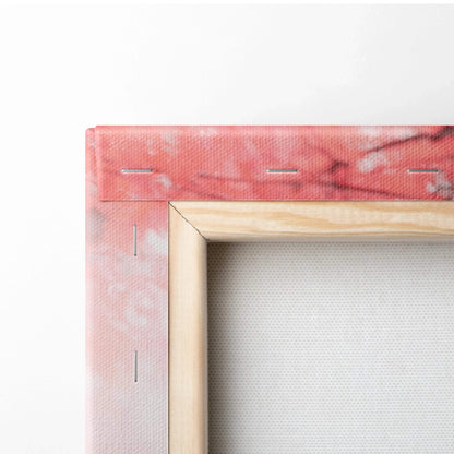 Close-up of wooden frame corner with pink printed canvas stretched and stapled for wall art canvas print.