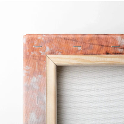 Close-up of wooden stretcher frame with staples securing canvas for vertical wall art.