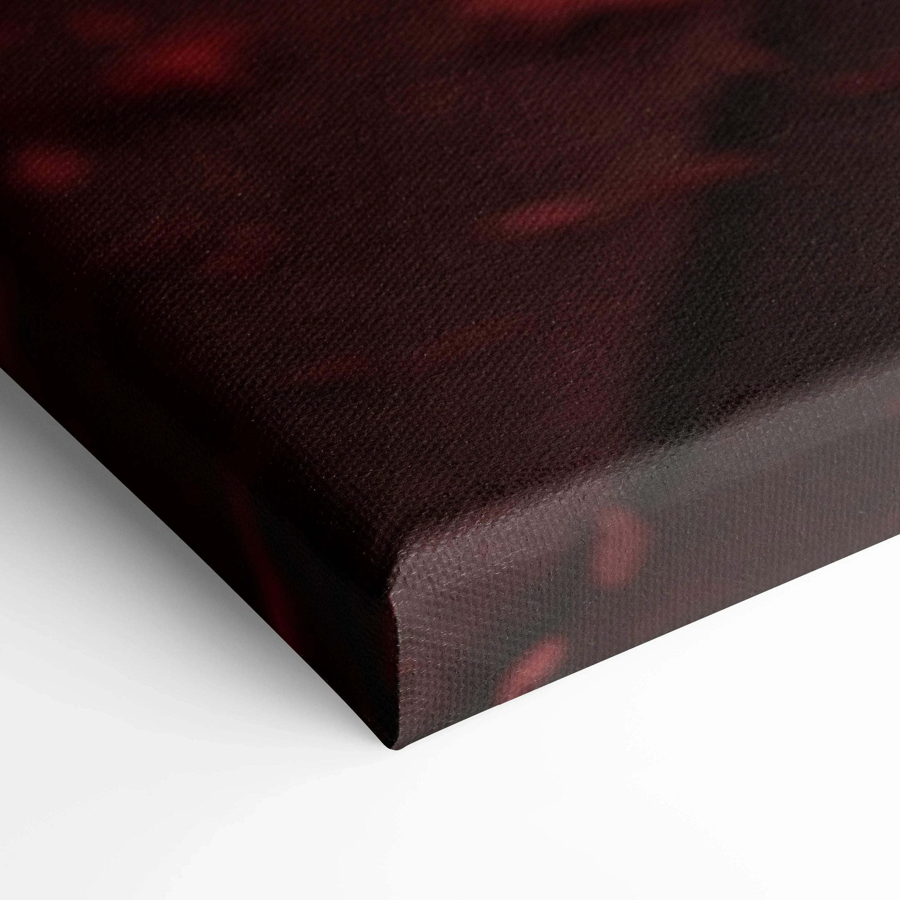 Close-up of textured black and red canvas wall art with museum-quality finish and wrapped edges.