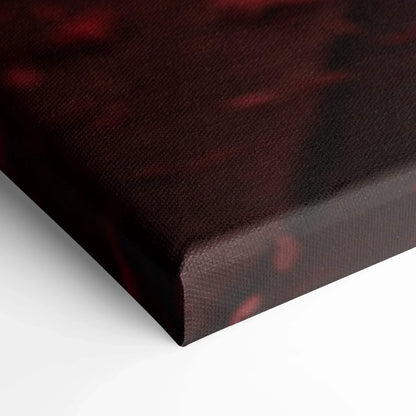 Close-up of textured black and red canvas wall art with museum-quality finish and wrapped edges.