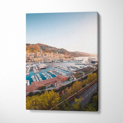 Canvas wall art featuring a sunlit marina and hillside town in warm tones.