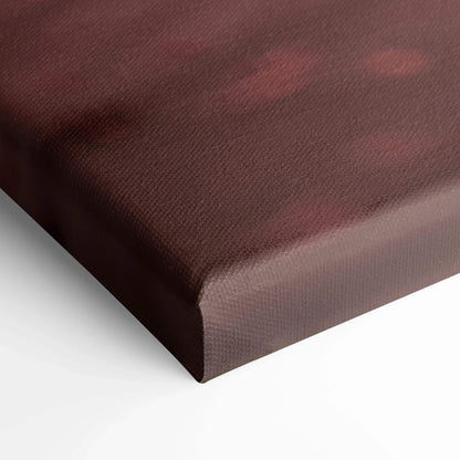 Close-up of burgundy and black abstract design on a textured canvas wall art print edge.
