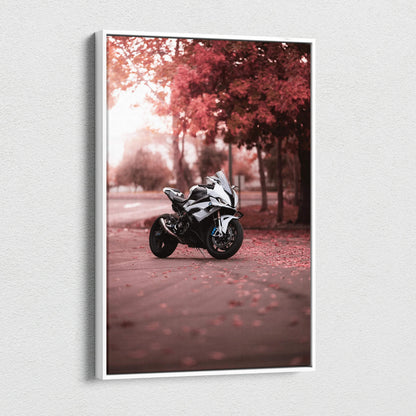 Vertical canvas art of a BMW S1000RR motorcycle parked on a leaf-covered path with autumn trees in the background.
