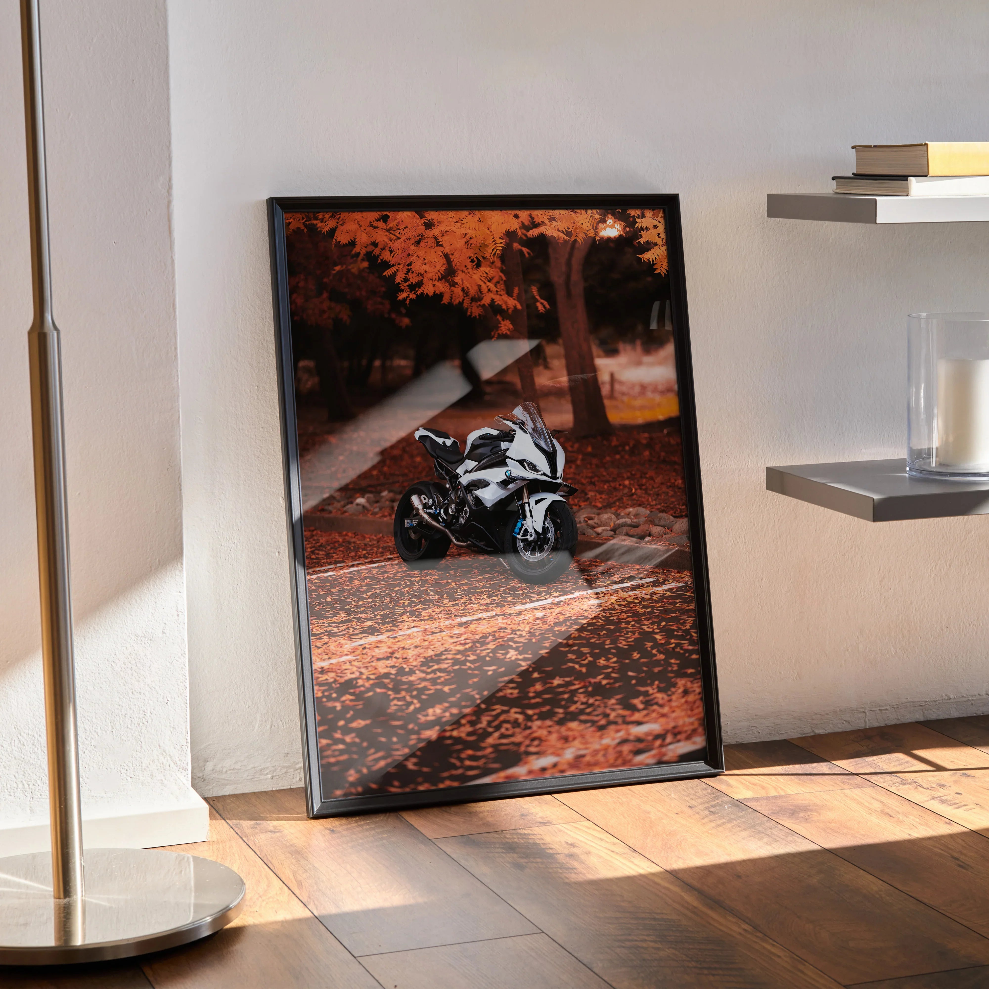 BMW S1000RR racing motorcycle poster leaning against wall with autumn leaves wall art.