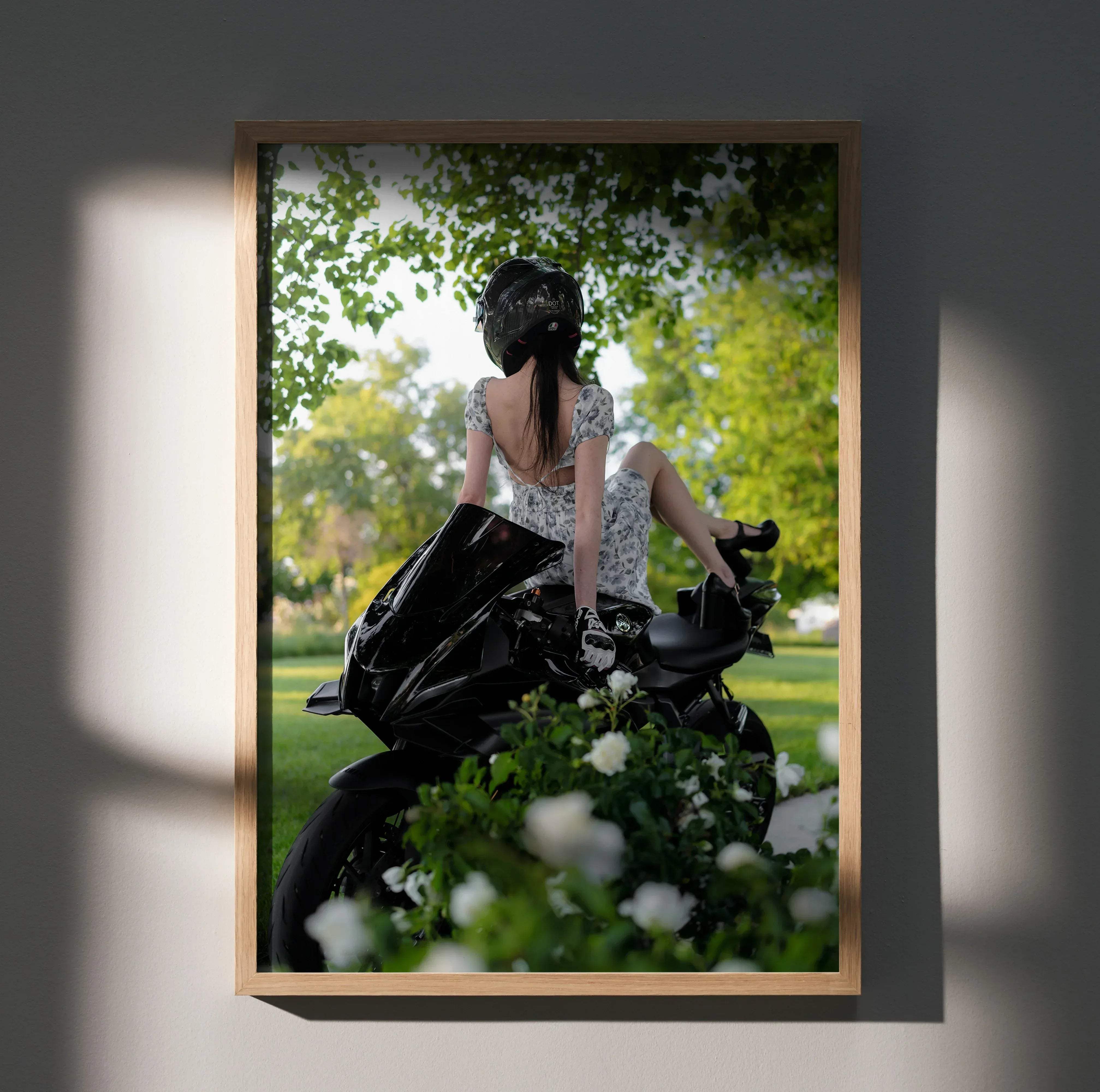 A framed biker poster featuring a woman in a floral dress with a black agv pista helmet on a glossy yamaha r7 motorcycle