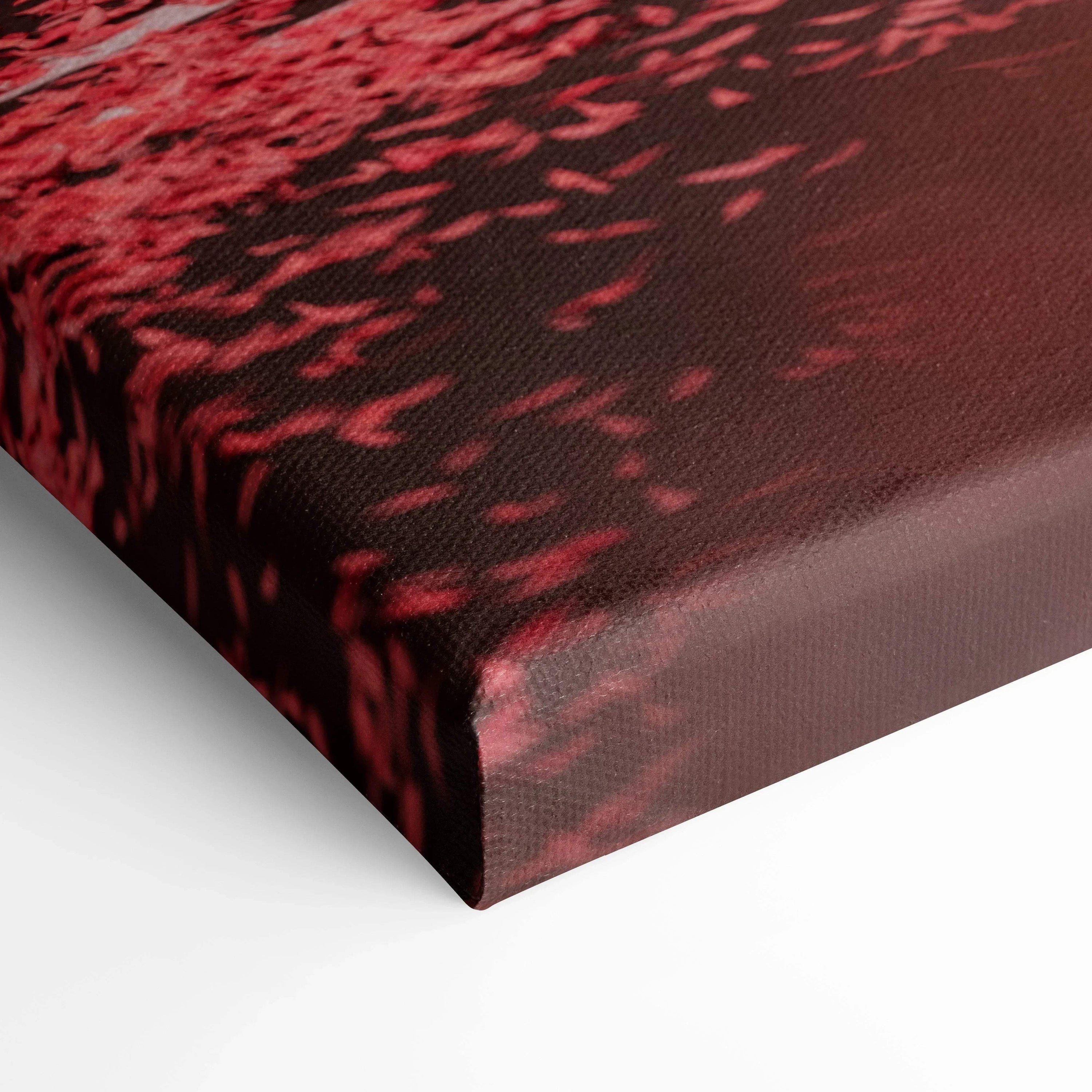 Close-up of red and black textured canvas wall art with detailed fabric weave on vertical canvas print edge.