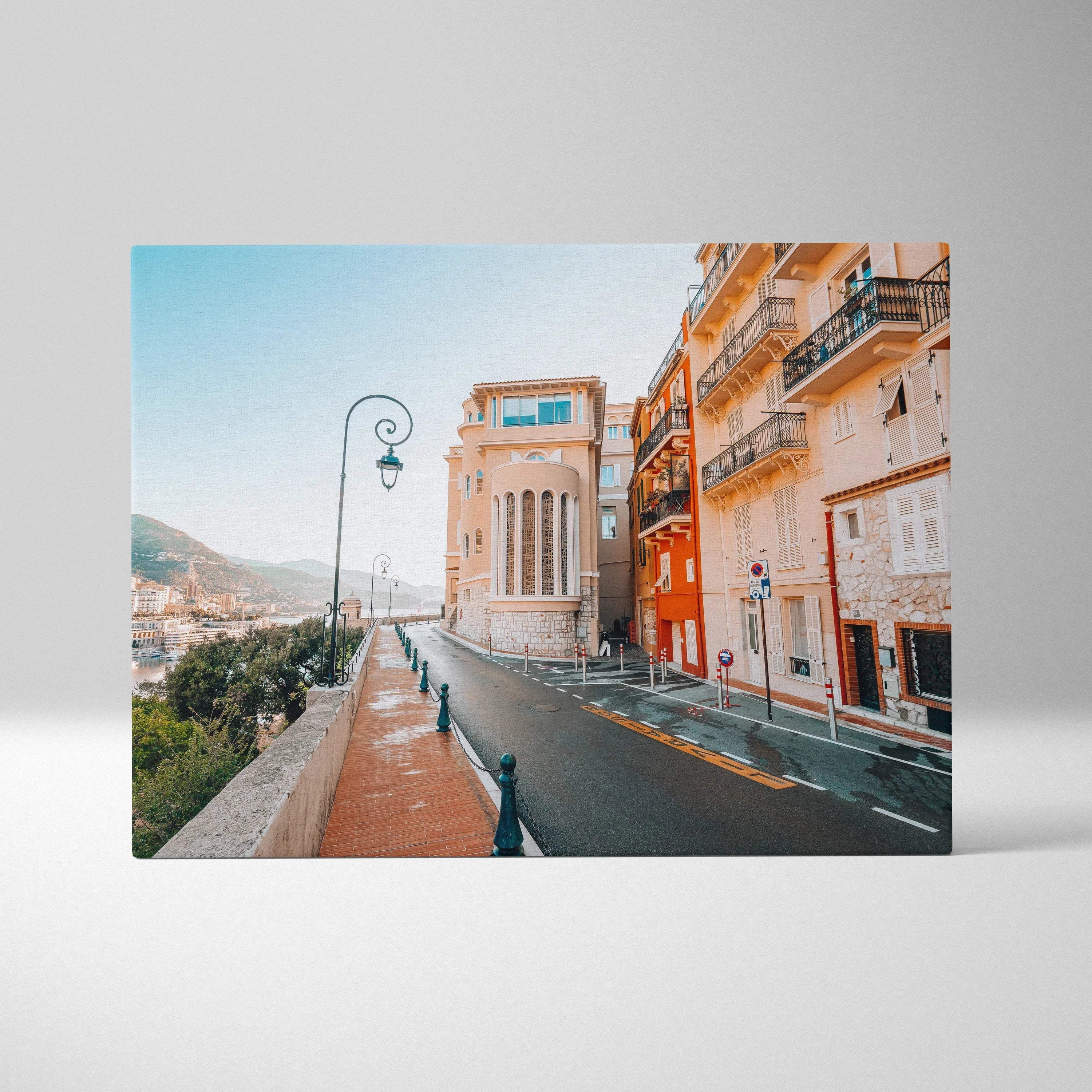 Canvas wall art print featuring a sunlit modern building facade with beige and orange tones on a quiet street under a clear.