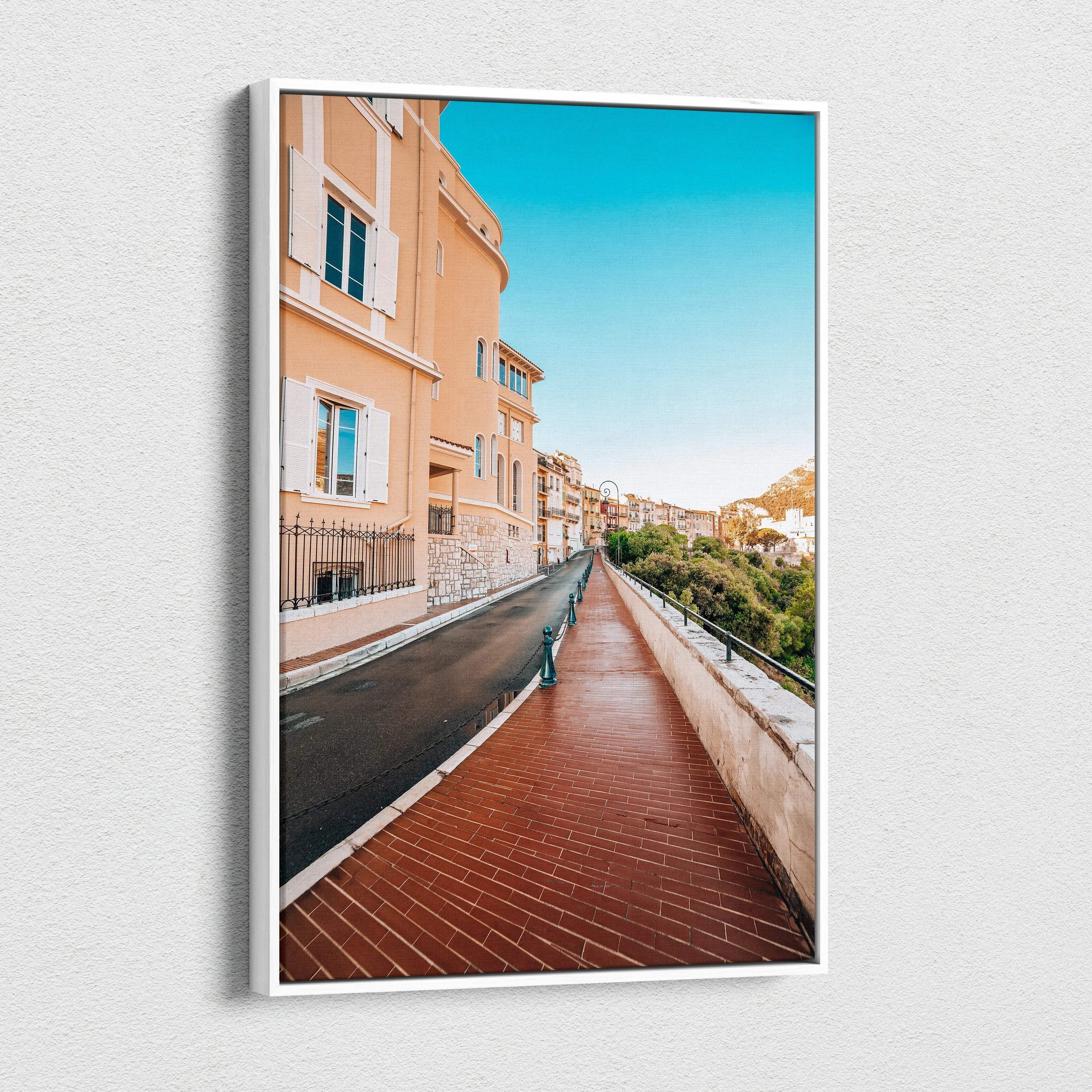 High-resolution canvas wall art featuring a vibrant street scene with peach-colored buildings, a brick walkway, and clear.