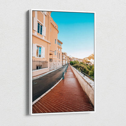 High-resolution canvas wall art featuring a vibrant street scene with peach-colored buildings, a brick walkway, and clear.