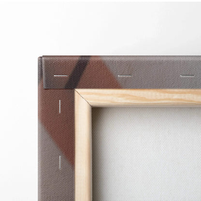Close-up of wooden stretcher frame with brown canvas wrapped and stapled at the corner.