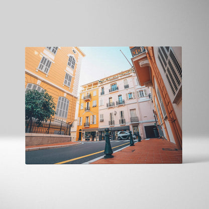 Canvas wall art featuring bright orange and white European-style buildings under a clear blue sky, showcasing architectural.