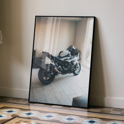 BMW S1000RR motorcycle poster leaning on wall showcasing sleek black and silver sportbike wall art.