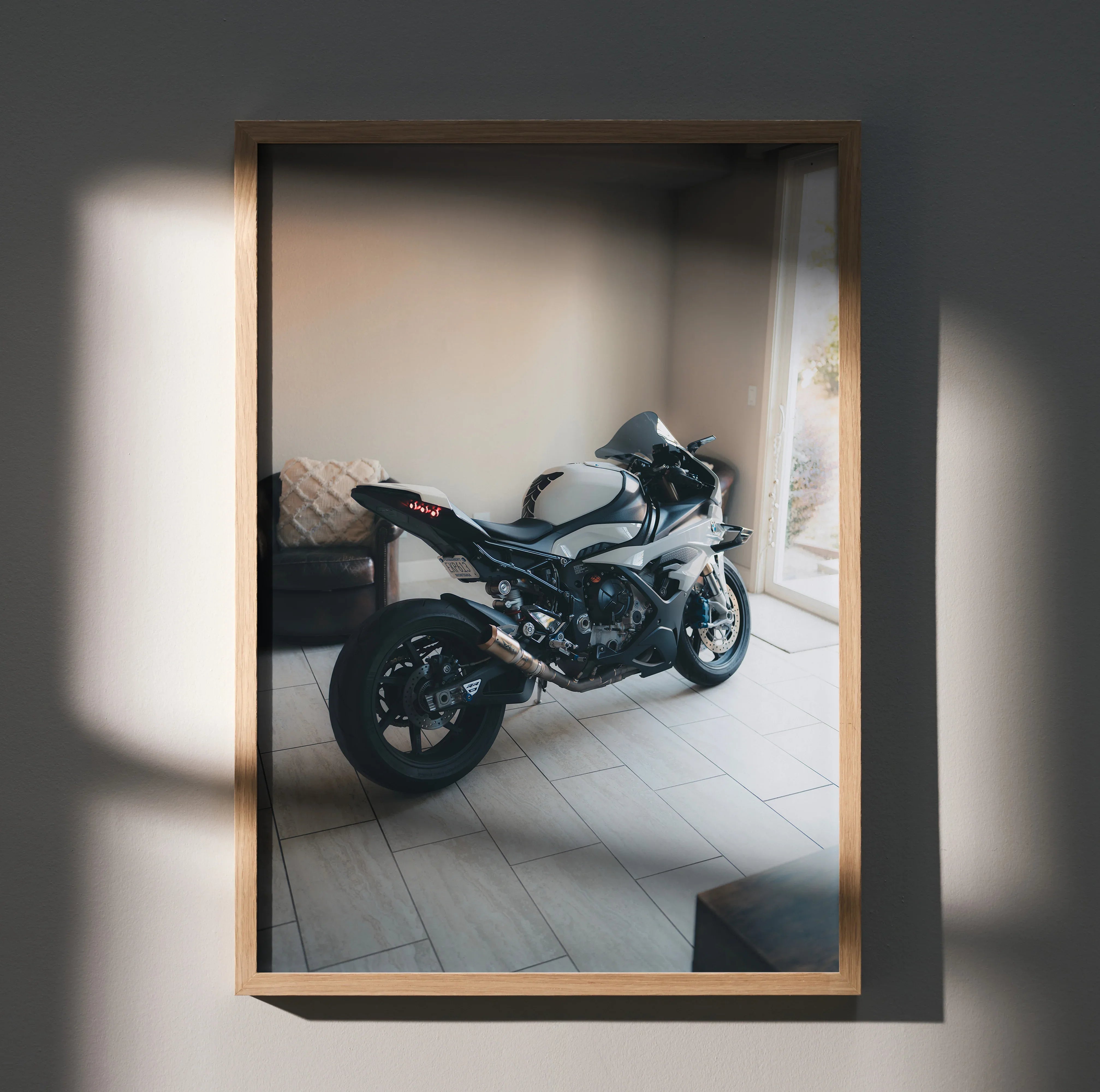 BMW S1000RR motorcycle poster wall art in wooden frame with natural light shadows.