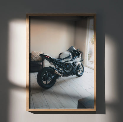 BMW S1000RR motorcycle poster wall art in wooden frame with natural light shadows.