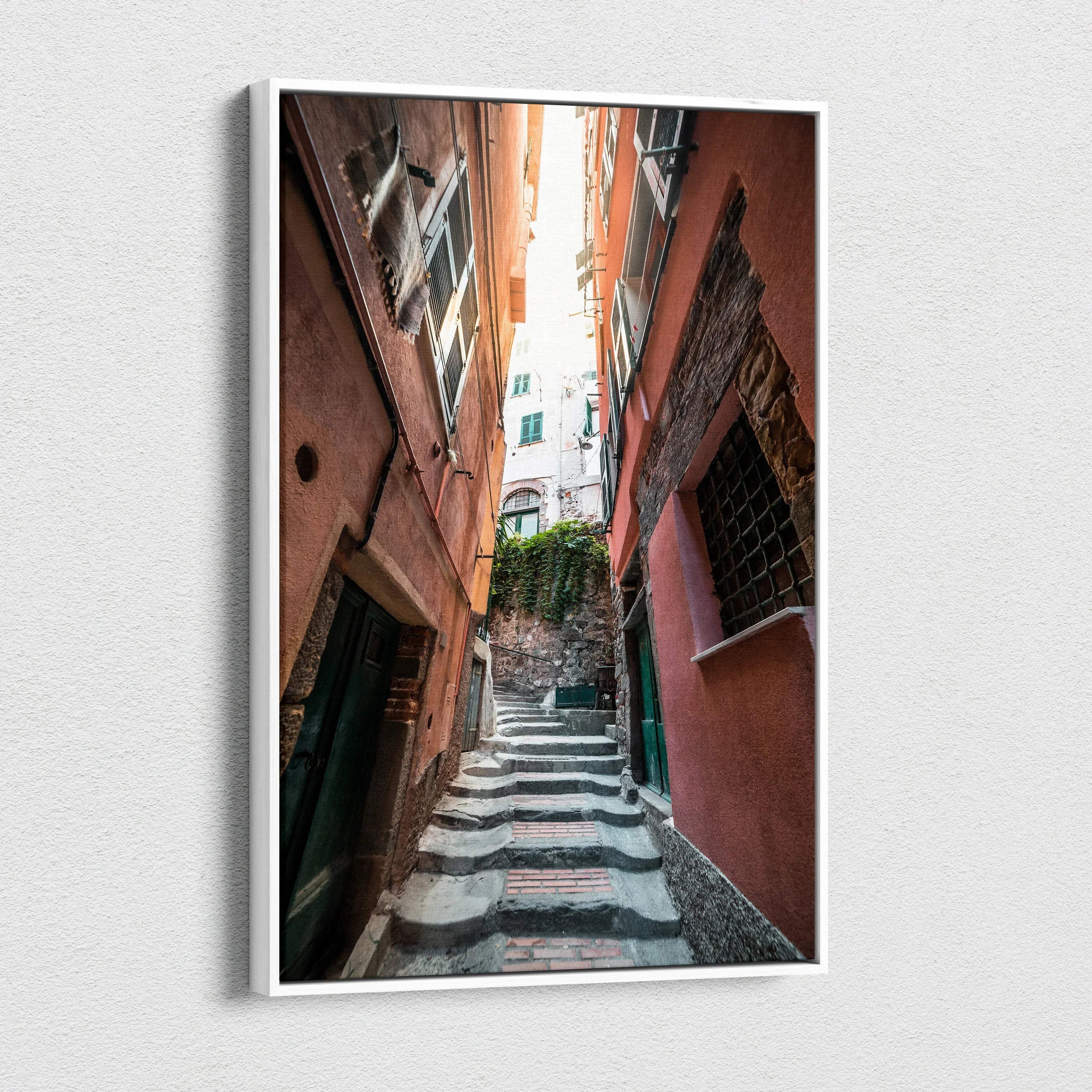 Vertical canvas art print depicting narrow stone steps flanked by tall, weathered buildings in warm tones with architectural