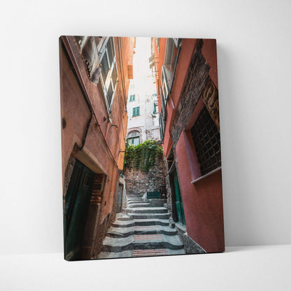 Canvas wall art featuring a narrow, sunlit alley between tall, warm-toned buildings with stairs leading upward.
