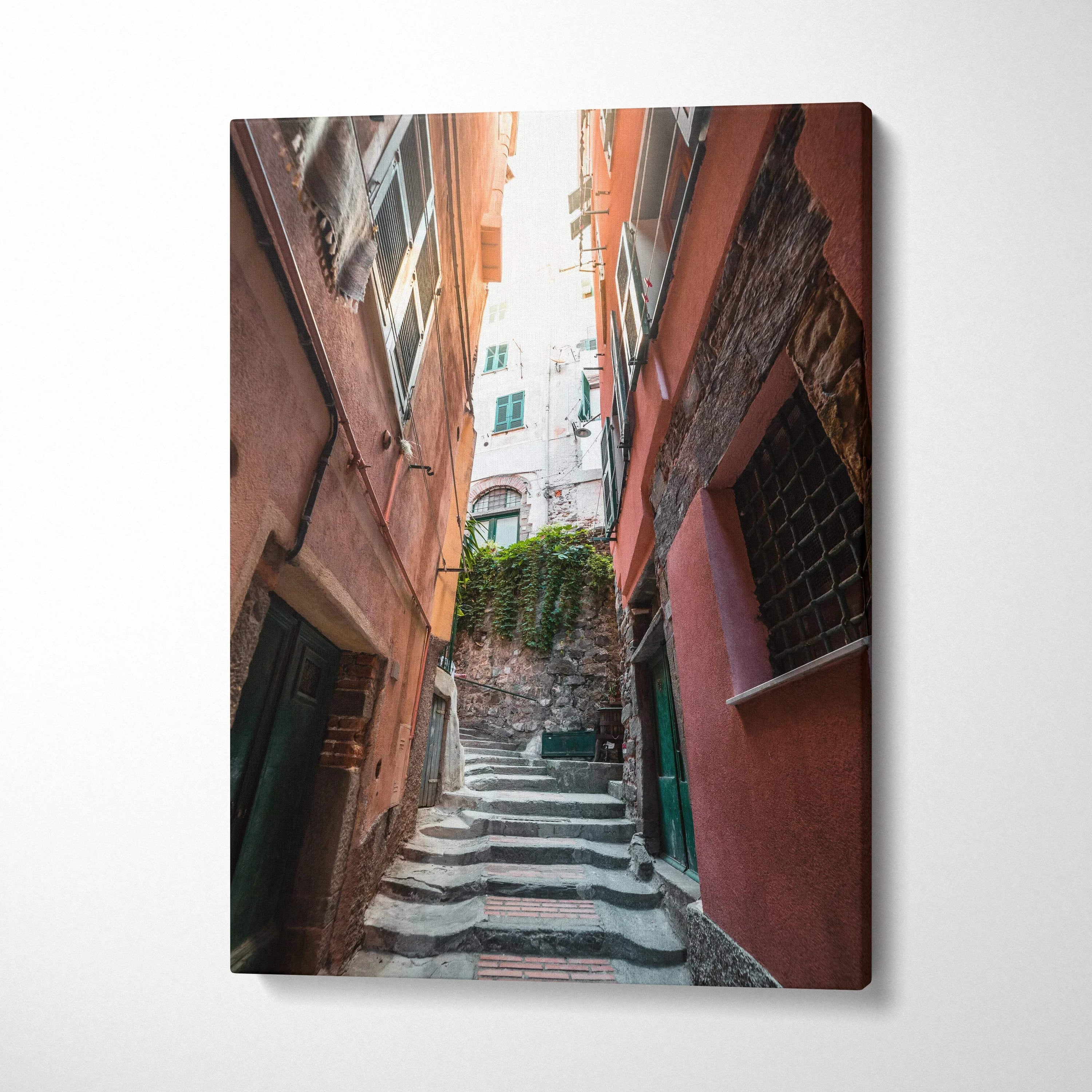 Vertical canvas art featuring narrow European alley with stairs and warm-toned buildings, modern wall art.