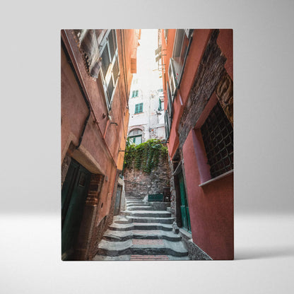 Vertical canvas art of narrow European street with ascending stone steps and reddish walls.