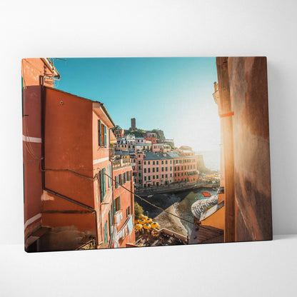 Canvas wall art featuring colorful architecture with warm orange buildings and a bright blue sky background.