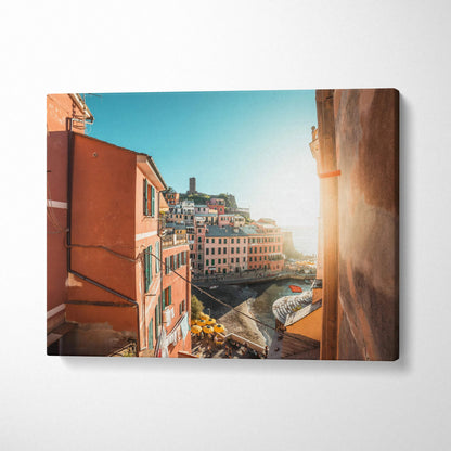 Sunlit coastal town architecture on canvas wall art with warm tones and bright sky.