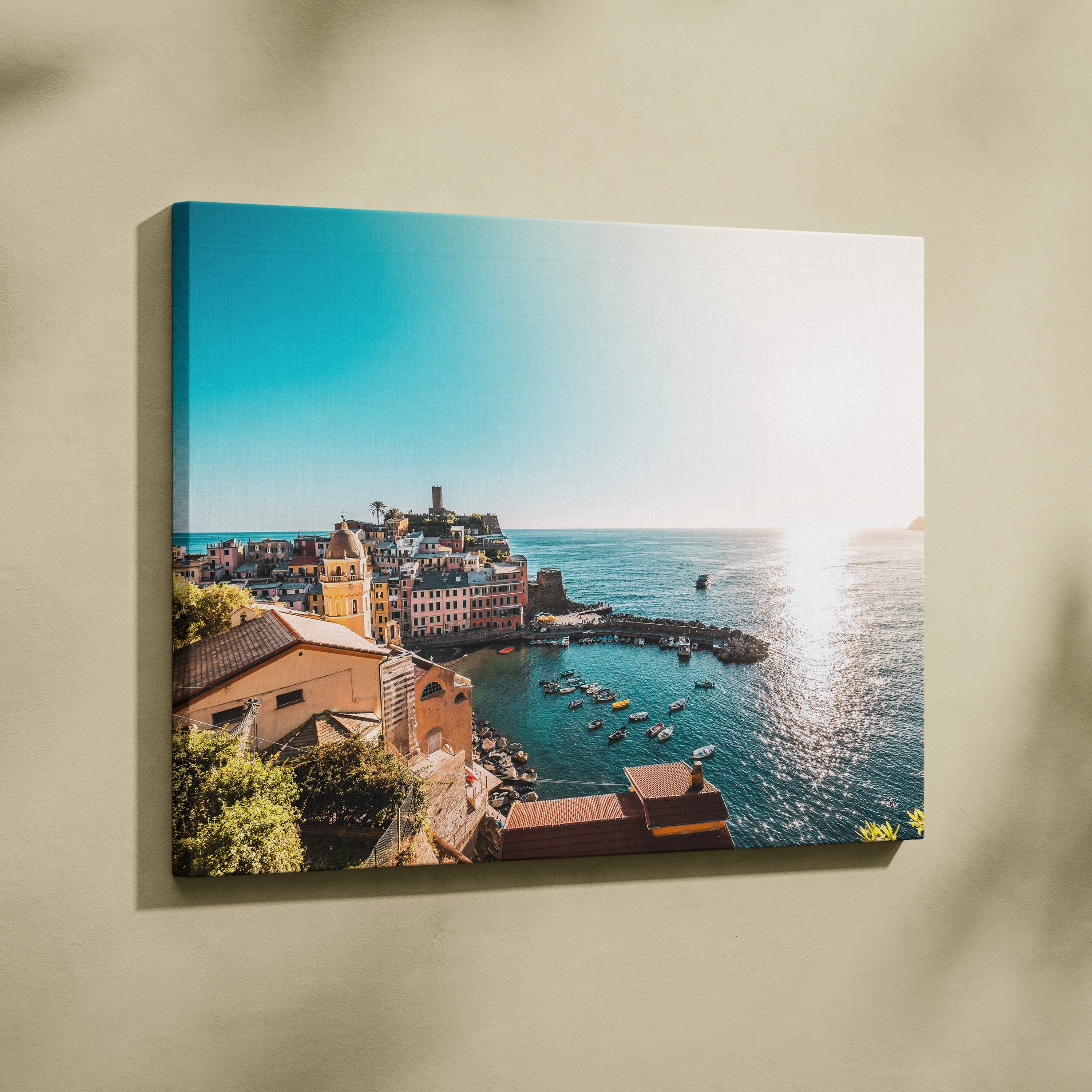 Canvas wall art featuring coastal architecture with vibrant buildings overlooking a sparkling blue ocean under a clear sky.