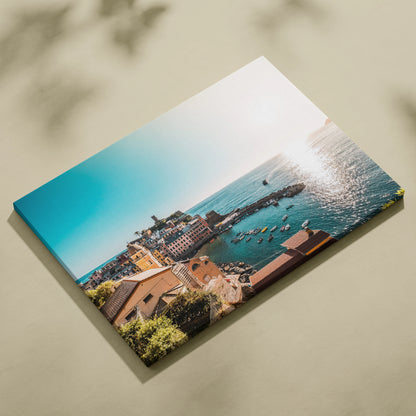 Coastal cityscape with detailed buildings and ocean view canvas wall art in bright sunlight.