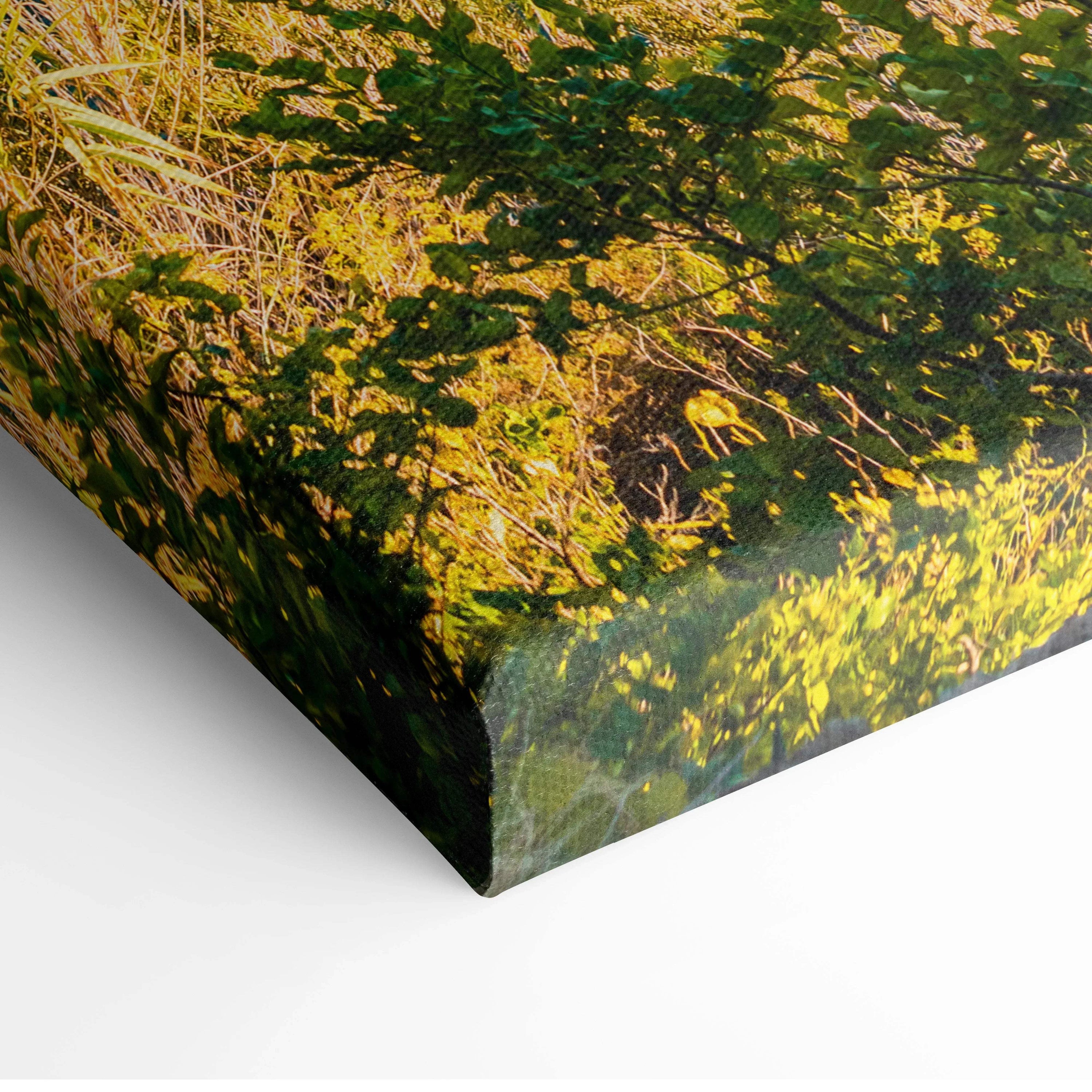 Close-up of canvas wall art print with detailed green and yellow foliage design, wrapped edge on stretched frame.