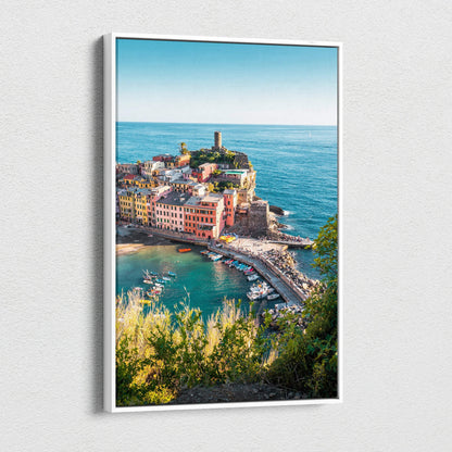 Framed canvas wall art featuring colorful coastal buildings and a lighthouse under a clear blue sky.