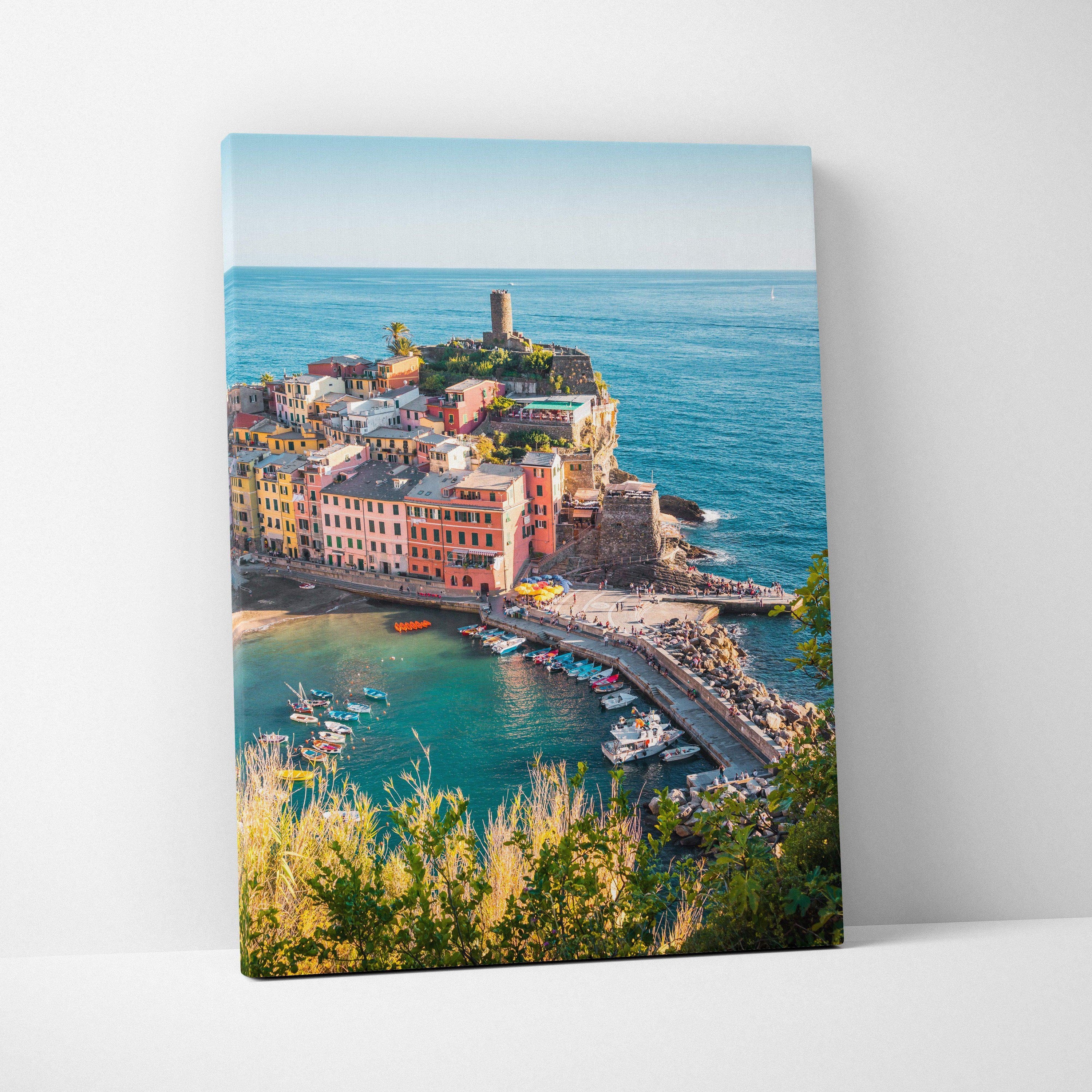 Canvas wall art featuring vibrant coastal buildings and a pier against a clear blue sea and sky.