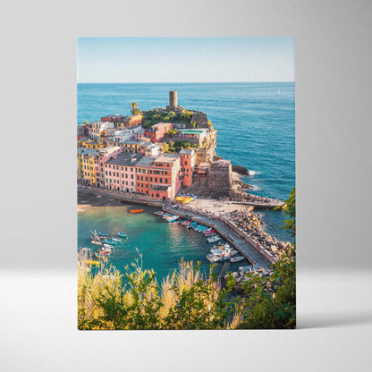 Vertical canvas wall art featuring colorful coastal buildings and a lighthouse over blue sea.