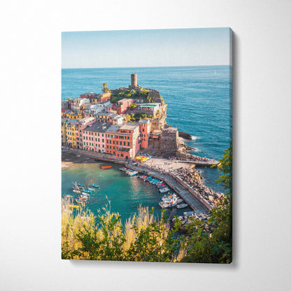 Vertical canvas wall art featuring colorful coastal village and ocean view with boats at harbor.