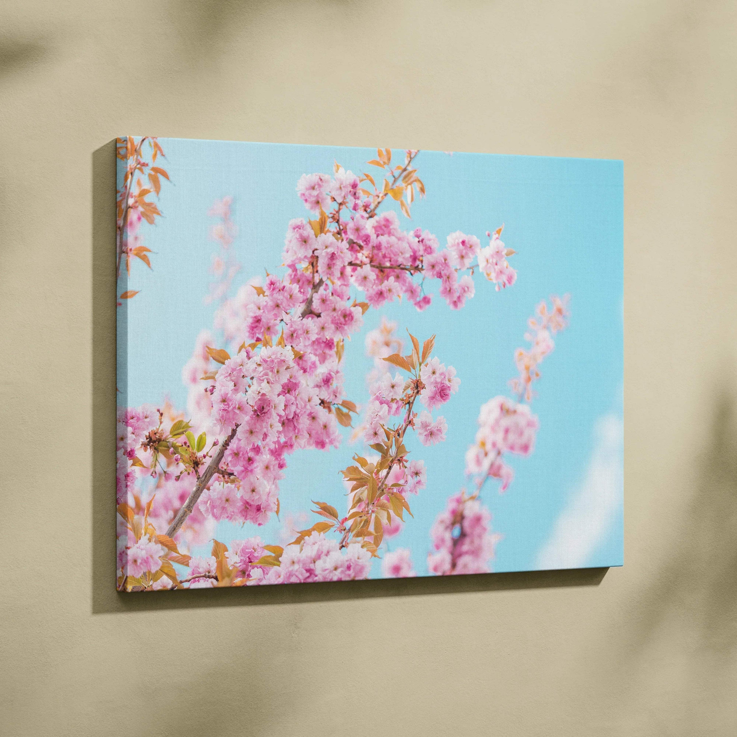 Canvas wall art featuring vibrant pink flowers against a bright blue sky, elegant home decor.