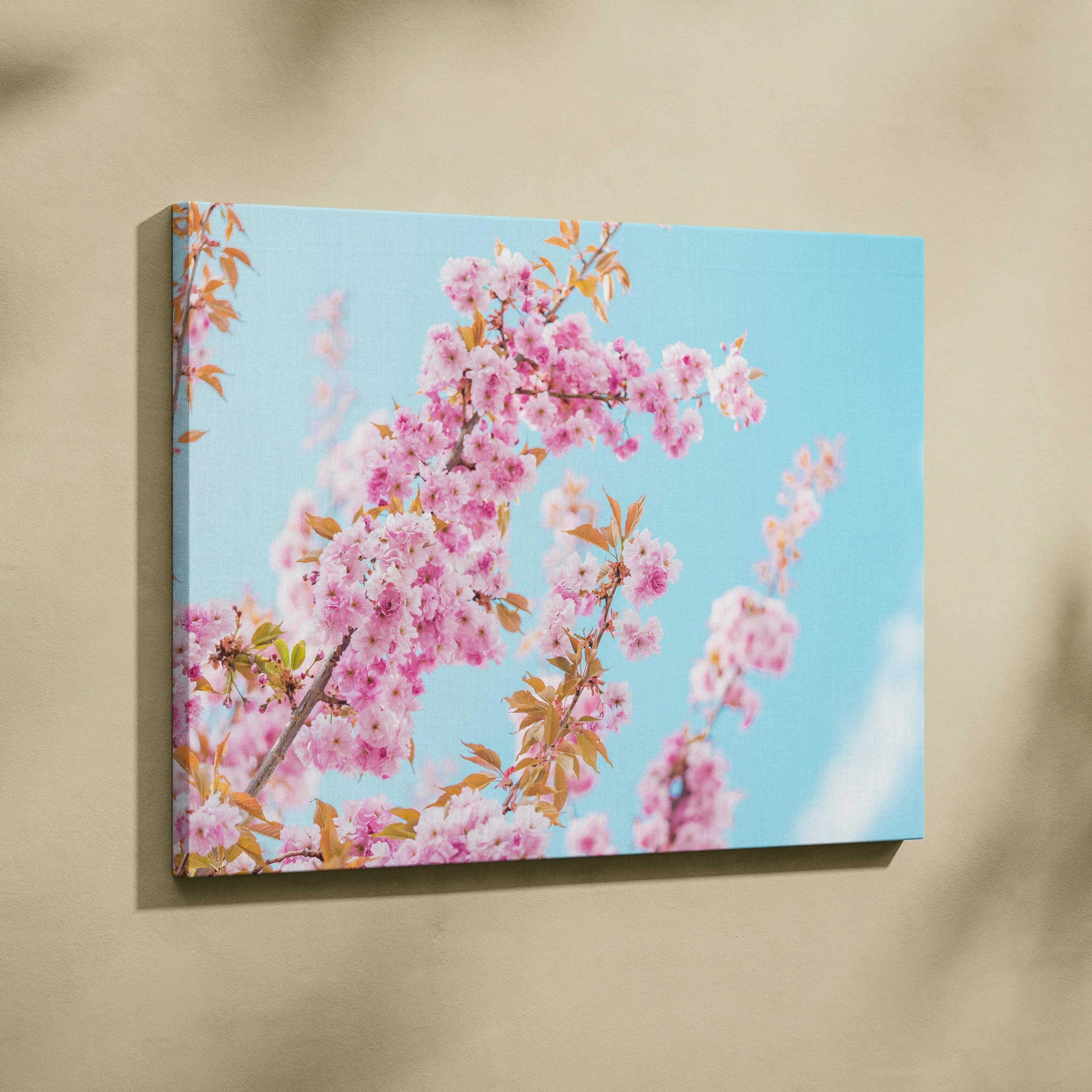 A rectangular canvas wall art featuring vibrant pink cherry blossoms against a serene blue sky for elegant home decor