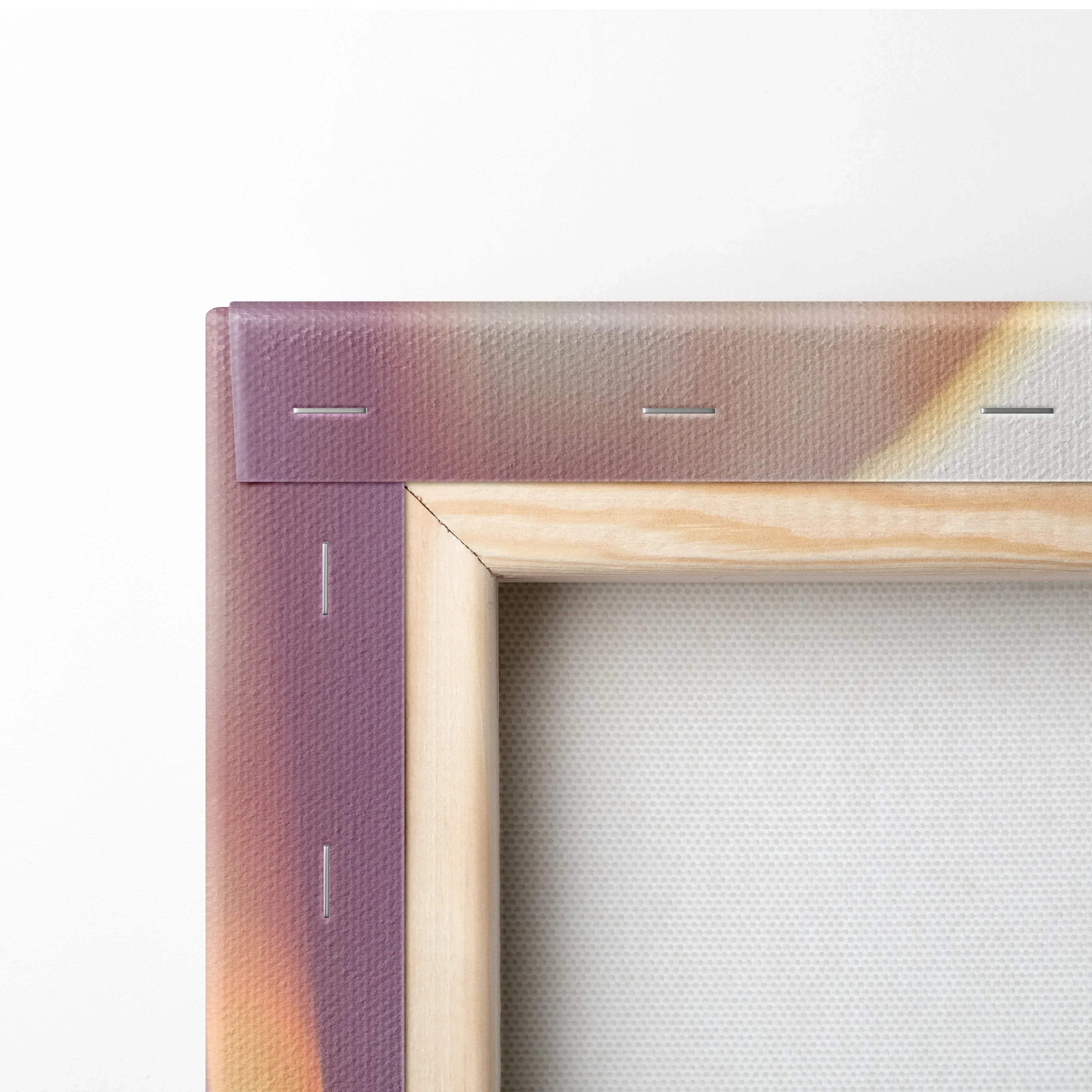Close-up of canvas wall art corner with wooden stretcher bars and floral print edge in purple and beige tones.