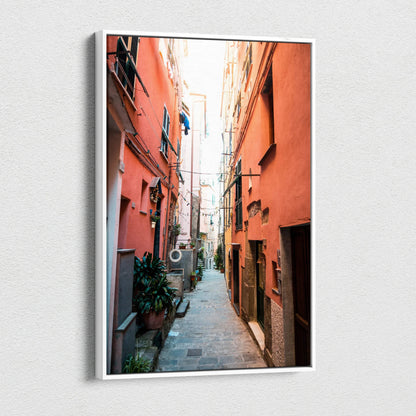Vertical canvas wall art featuring a vibrant narrow alley with orange buildings and detailed architecture.