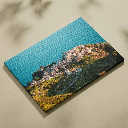 Canvas wall art featuring aerial view of coastal buildings and ocean with vibrant blue and green hues.